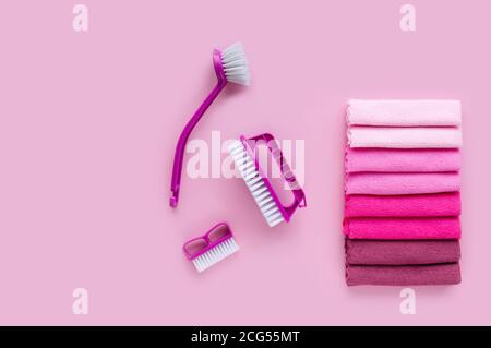 Professional set for general house cleaning. Multi-colored microfiber cleaning towels and purple brushes. Flat lay. Copy space. Stock Photo
