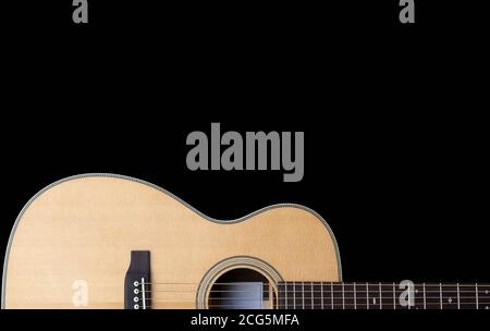 classic steel string acoustic guitar on a black background with white music notation Stock Photo