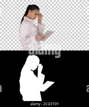 Woman doctor using tablet pc and walking, Alpha Channel Stock Photo