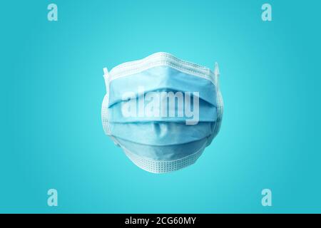 A plain blue medical Surgical protection face mask. Front facing view. Stock Photo