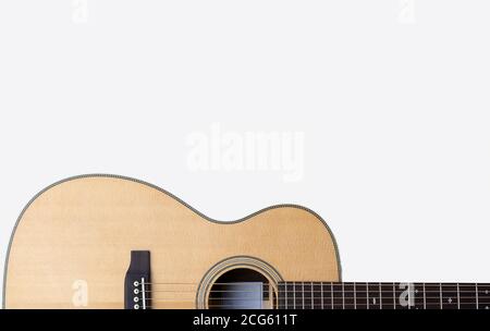 classic steel string acoustic guitar on a white background with white music notation Stock Photo