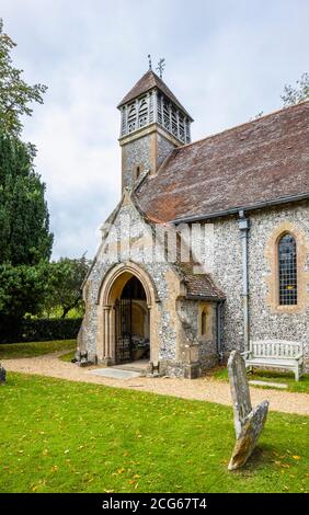 Entrance to the parish church of All Saints with flint lined walls, Hinton Ampner, Upper Itchen Benefice, Bramdean, Alresford, Hants, southern England Stock Photo