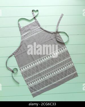 kitchen apron of gray color on turquoise background Stock Photo