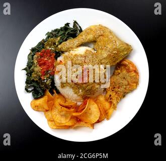 Delicious Padang Rice with chicken curry - Nasi Padang Stock Photo