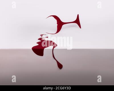 Conceptual red wine glass with spilled wine Stock Photo