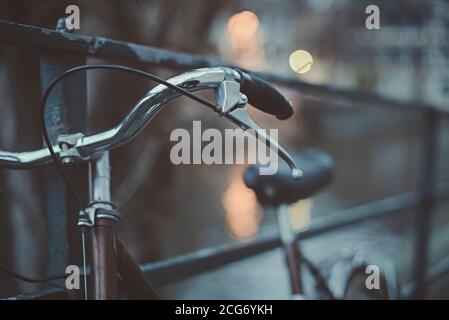 Close-up of a bicycle leaning against metal railings, France Stock Photo