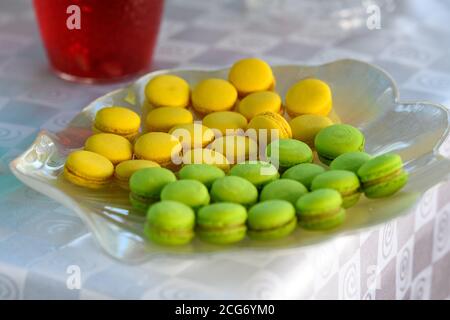 Lemon and pistachio Macaroons on serving plate Stock Photo
