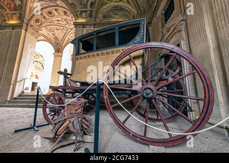 Antique carriage located in a museum-palace in a room with frescoes painted on the ceiling Stock Photo