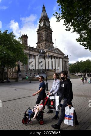 Bolton, Lancashire, 9th September 2020. The people of Bolton face their first full day of a new stricter lockdown today. Pubs, bars and restaurants are only allowed to serve a take away service, while it is not allowed to meet anyone from outside your family. People in masks walk past Bolton Town Hall on Victoria Square. Credit: Paul Heyes/ Alamy Live News Stock Photo