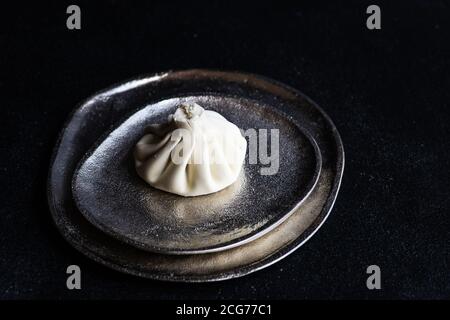 Traditional Georgian khinkali dumpling on a metal dish Stock Photo