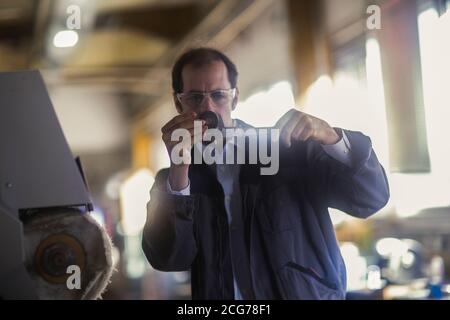 Engineer measuring a machine part in an industrial plant, Germany Stock Photo
