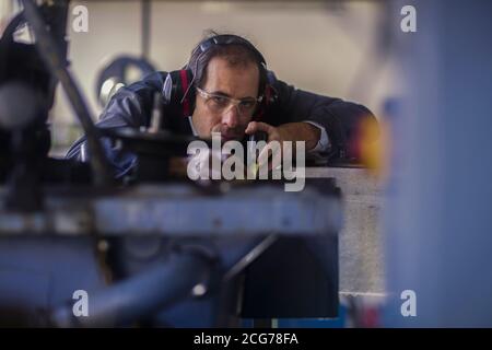 Engineer inspecting a machine part in an industrial plant, Germany Stock Photo