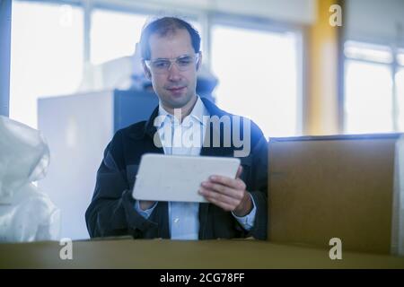 Engineer using a digital tablet in a factory, Germany Stock Photo