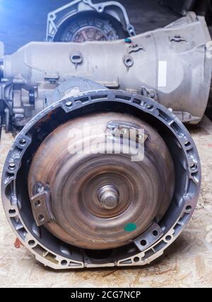 An automatic transmission removed from a car in a car workshop for auto-analysis. The pump wheel is connected to the engine crankshaft, the turbine is Stock Photo