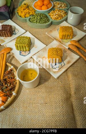 Mid-Autumn Festival moon cake, colorful food and drink on burlap background. Travel. holiday, food concept Stock Photo