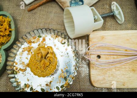 the wooden mold for moon cake, homemade cantonese moon cake pastry on baking tray before baking for traditional festival. Travel, holiday, food concep Stock Photo