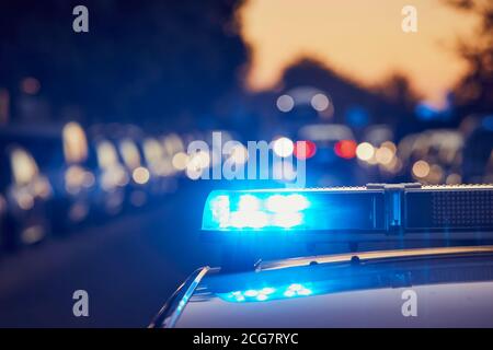 Siren light on roof of police car at street. Themes crime, emergency and help. Stock Photo
