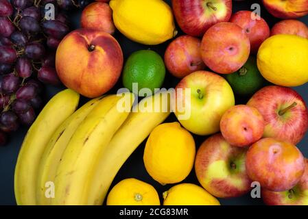 above view of fresh organic fruits on black table Stock Photo