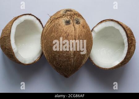 One whole coconut and two halves isolated on white background. Stock Photo