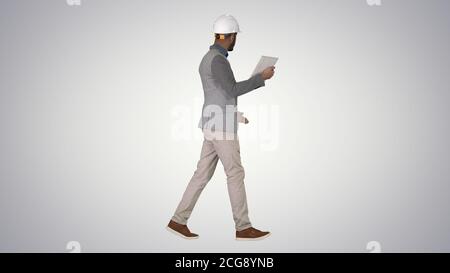 The hipster engineer making video call with tablet showing result of his work on gradient background. Stock Photo