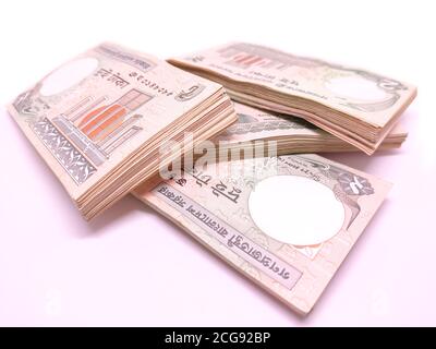 Stacks of two taka Bangladeshi banknotes close-up isolated on white background Stock Photo