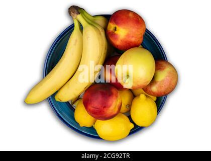 above view of fruit bowl with fresh organic bananas, apples, nectarines and lemons Stock Photo