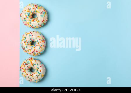 Tasty donuts on two tone background, top view Stock Photo