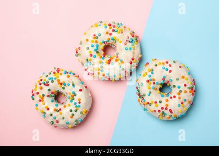 Tasty donuts on two tone background, top view Stock Photo