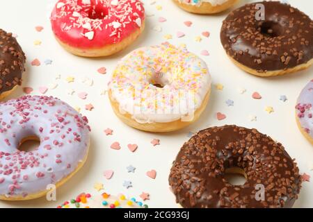 Flat lay with tasty donuts on white background Stock Photo
