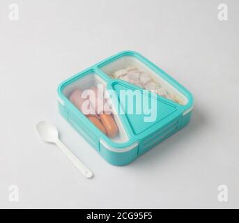Tiffin box carrier and spoon with food isolated on white background Stock Photo