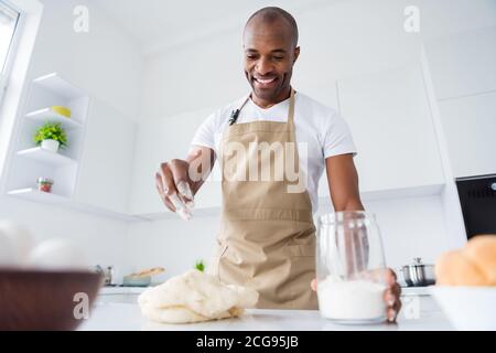 Portrait of his he nice attractive confident cheerful guy confectioner preparing fresh bread pizza pie pide doughing flour learning spending free time Stock Photo