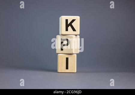 Concept word 'KPI, key performance indicator' on cubes on a beautiful grey background. Business concept. Copy space. Stock Photo