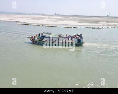 MAWA, BANGLADESH - MARCH 09, 2020: Passengers cross Padma river on ferry boat at Mawa, Bangladesh. Ferry boats are often overloaded in Bangladesh and Stock Photo