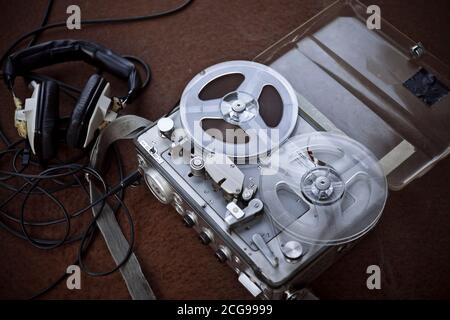 Vintage bobbin audio player with headphones and selective focus Stock Photo