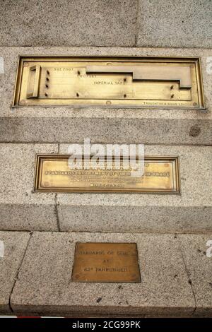 Brass plaque of the imperial standards of length seen against the north wall near the the cafe on Trafalgar Square London. Stock Photo