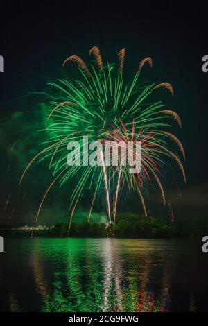 Green burst of fireworks celebration on the 4th of July over Lake Julian in Arden, North Carolina Stock Photo