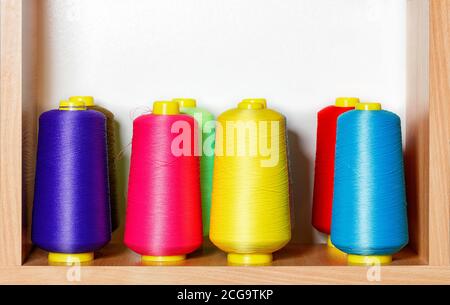 Bobbins of multicolored silk threads for embroidery and professional embroidery machines. Stock Photo