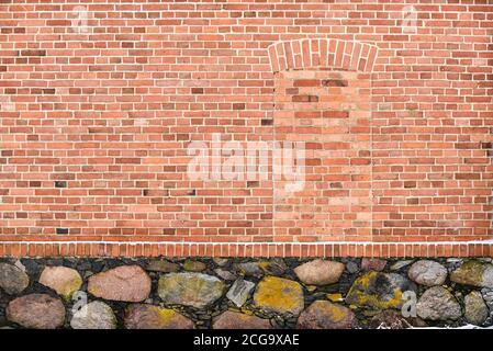 Old wall from bricks and large stones Stock Photo