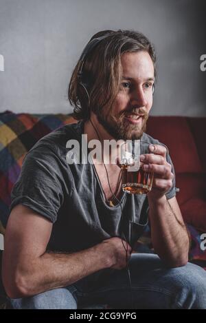 Bearded man listening to music with headphones Stock Photo