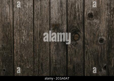 old shabby gray fence made of wooden boards. background texture wall Stock Photo