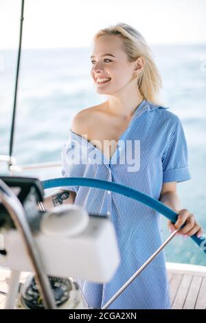 Attractive strong woman sailing with her boat Stock Photo