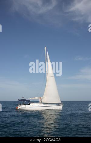 Sailing ship yacht with white sail in the open sea heading to neapolis coast Stock Photo