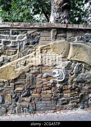 Ornamental detail on an old stone wall. Traditional and historical English wall detail in London. Stock Photo