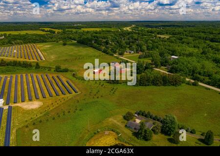 Soy versus Silicon, Farm with a traditional red barn and Solar Plant, Lapeer, Michigan, USA Stock Photo