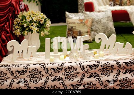 Indoors wedding reception venue with decor, selective focus on flowers Stock Photo
