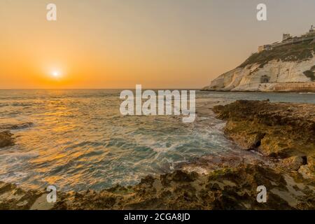 View of the sunset with the coast and cliffs of Rosh HaNikra, Northern Israel Stock Photo