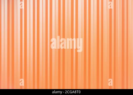 Sheet of orange corrugated metal fence background. Stock Photo