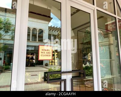Orlando, FL/USA - 6/13/20:  The storefront of the Tumi luggage retail store at an outdoor mall in Orlando, Florida with a sign that says Sorry we are Stock Photo