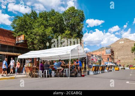Tourists enjoy a summer day; Bensen's Tavern & Beer Garden; pedestrian only historic F Street; Salida; Colorado; USA Stock Photo