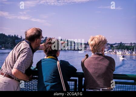 Passengers at railing of ferry boat arriving at Friday Harbor on San Juan Island, Washington USA Stock Photo
